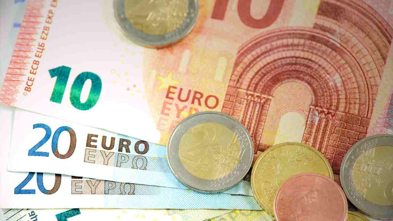 Varie banconote e monete di euro sul tavolo