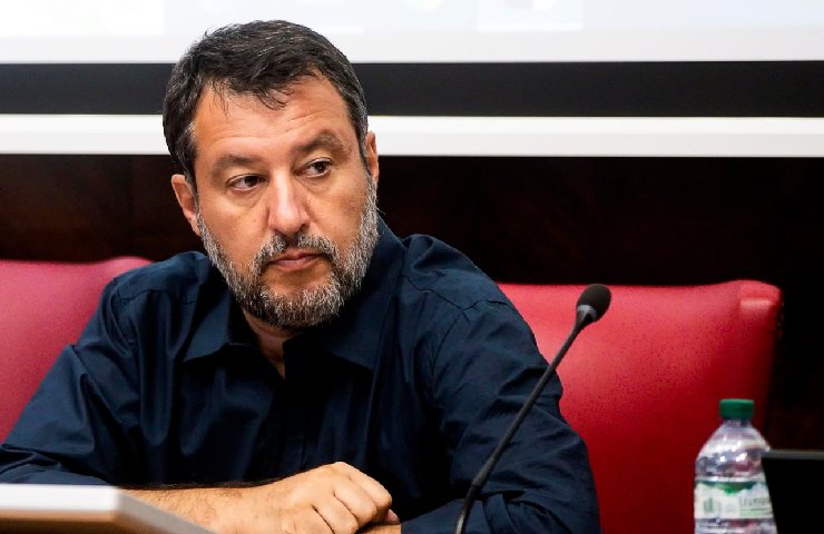 Il ministro Matteo Salvini davanti ad un microfono seduto su una sedia rossa